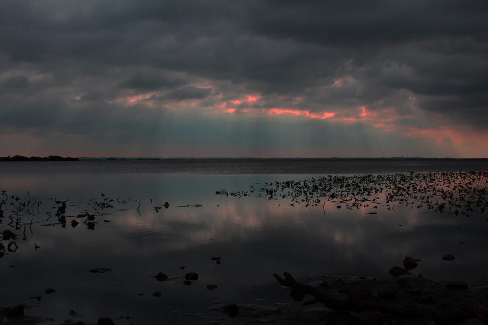 dark blue sky with pink over the lake