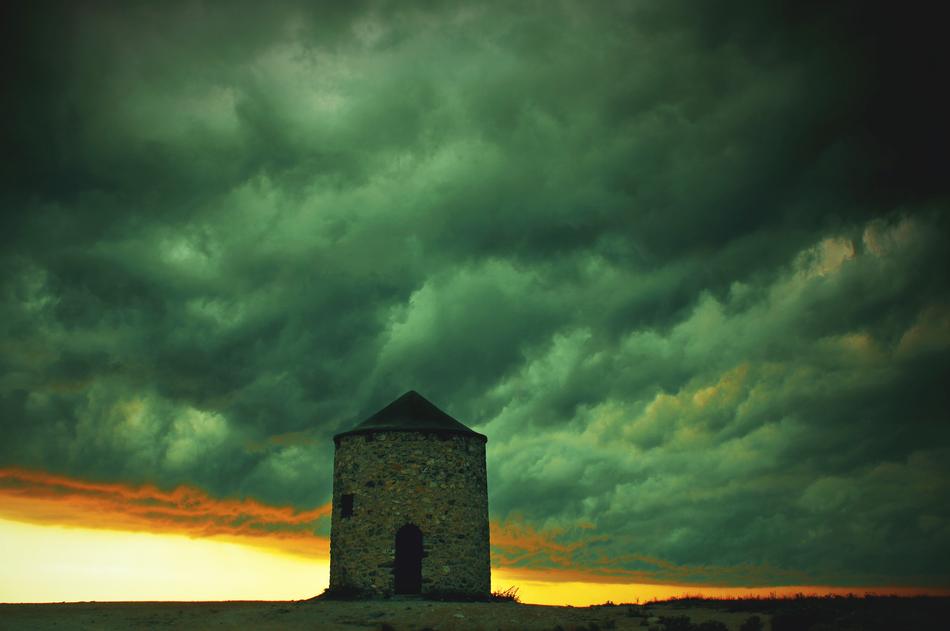 building against a background of thick clouds with a green hue