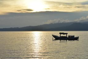 Amboina bay Boat Water at Sunset