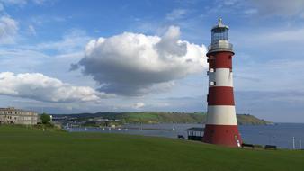 Red and white Lighthouse on Sea coastline