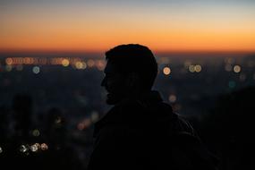 Male Silhouette at dusk, blur bokeh background