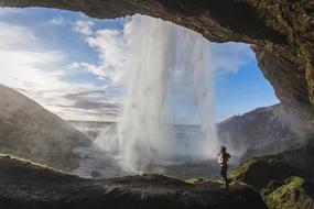 girl looks at Waterfalls from Cave in rock