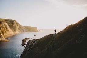 alone man on cliff