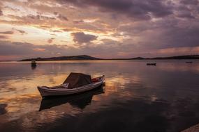 boat floating on the water during sunset