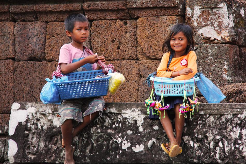 local children with baskets in siem reap, cambodia, asia