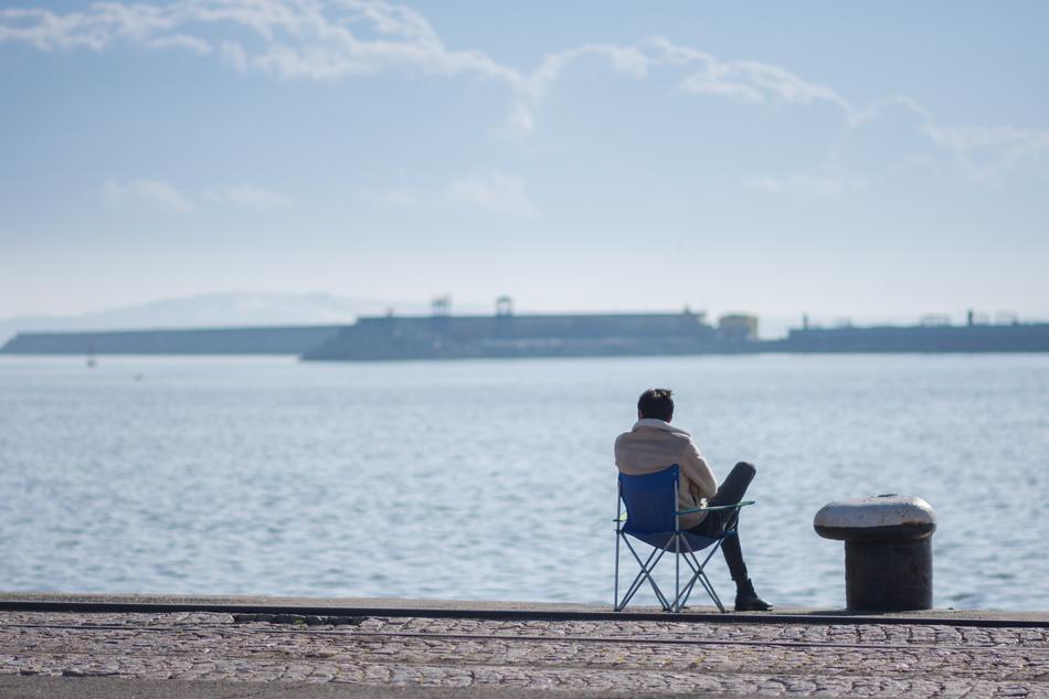 man resting on a chair by the sea
