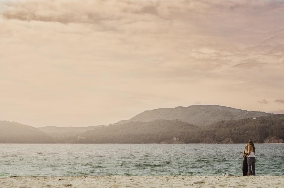 two women on beach at scenic coast