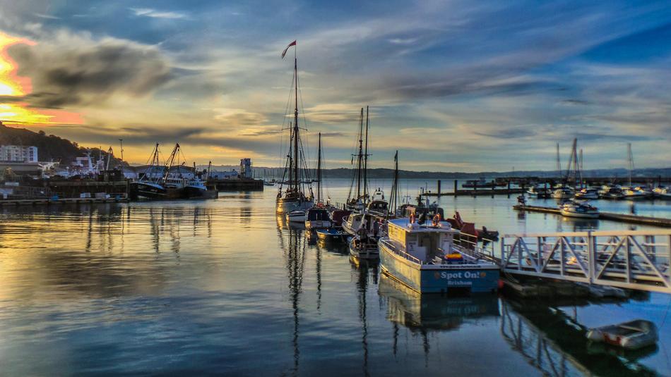 boat ships in harbour at sunset