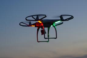 Drone Dji Phantom flying with photo camera at dusk