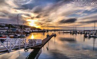 water sunset sky sea boats scene