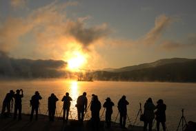 photographers on coast at sunset