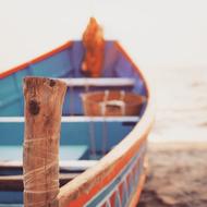 boat tied to a wooden pole