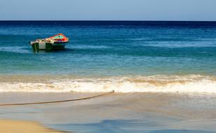 boat sailing away from the beach