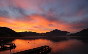 wooden pier with a bright sunset as a backdrop