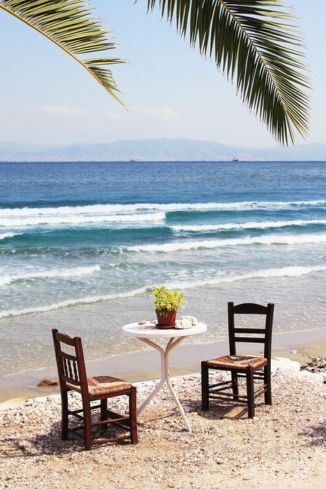 table and chairs on the ocean beach
