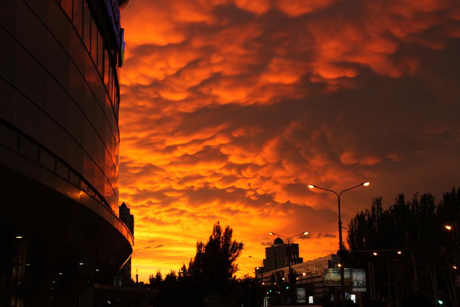 building with glass facades and a fiery sunset