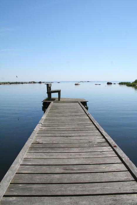 couch standing at the end of a wooden bridge