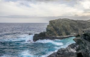 waves crashing against the rocks of the sea