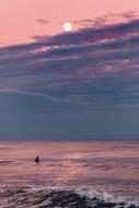lonely man at sea at sunset