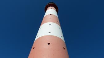 tall colored lighthouse in the sky