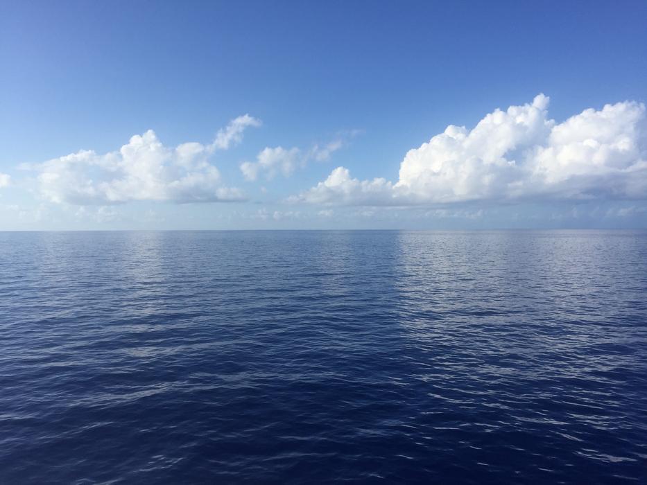 ocean surface against the blue sky