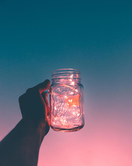 glowing jar of garlands in his hand