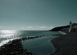long trail of rocks on the sea