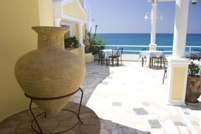 Greek old amphora on the balcony of the house