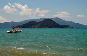 blue sea with mountain view