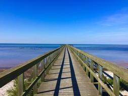 green long bridge by the sea