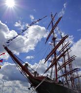 a big ship in the blue sky with clouds.