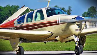airplane on the runway near the grass