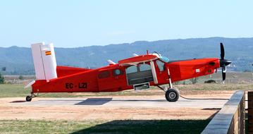 red helicopter on the pad