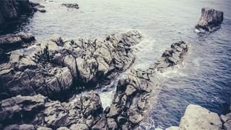large rocks protruding from the water