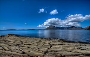 scenery on a stone beach with a lake