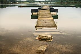 wooden ruined bridge in the lake