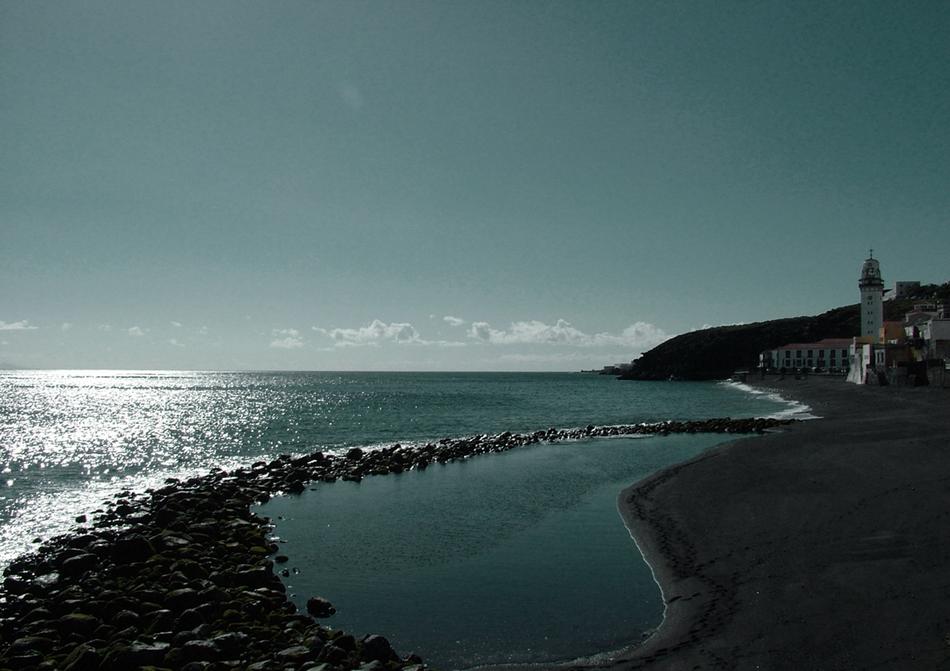long trail of rocks on the sea