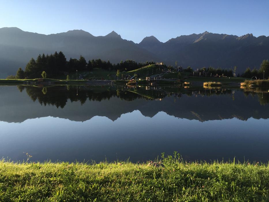 a bright landscape of houses by the lake