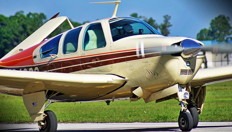 airplane on the runway near the grass