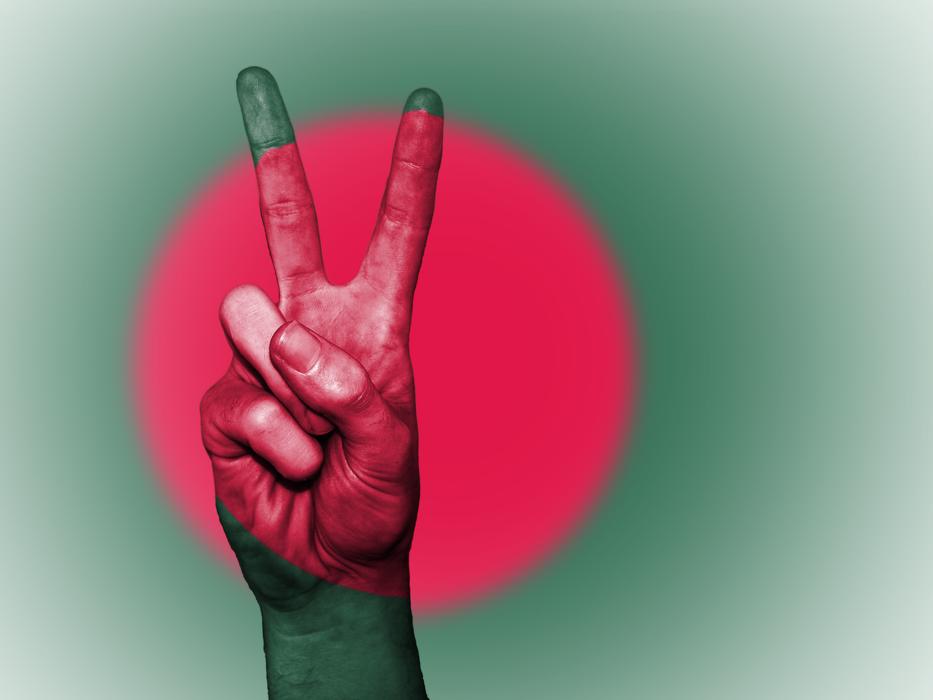 a peace sign on the hand of a man