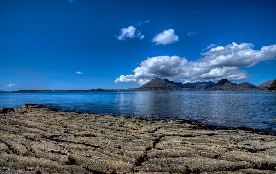 scenery on a stone beach with a lake