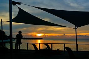 silhouette of a man against the sea