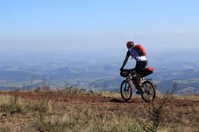 man on bicycle on a cliff
