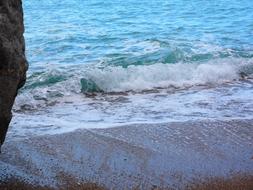 white waves crashing on the beach