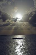 Boat on Sea beneath dramatic clouds