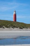 Lighthouse with red tower over Grass Dunes, netherlands, texel