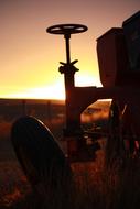 Silhouette of a water faucet against the sun