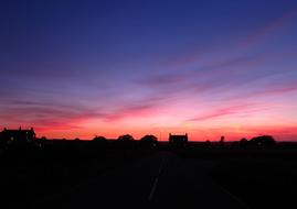 Silhouette of village at colorful Sunset Sky