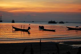 Boat silhouettes at sunset