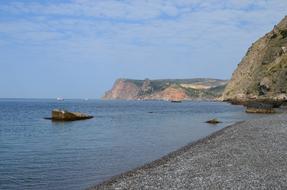 Rocks on grey pebble beach at Sea, russia, crimea